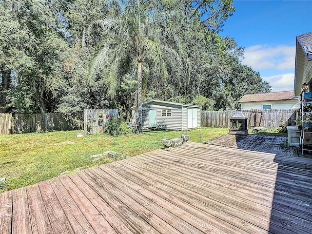 wooden deck with a yard and a storage unit