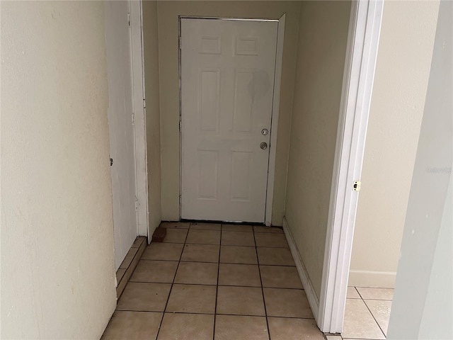 hallway featuring light tile patterned flooring