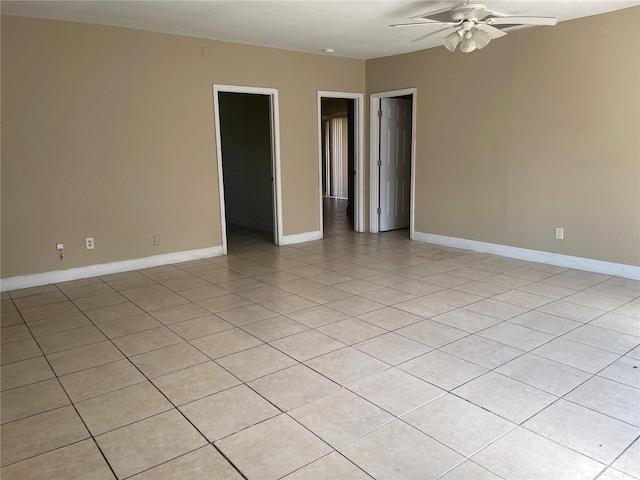 unfurnished room with ceiling fan and light tile patterned floors