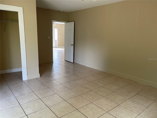 unfurnished bedroom featuring light tile patterned flooring and a closet