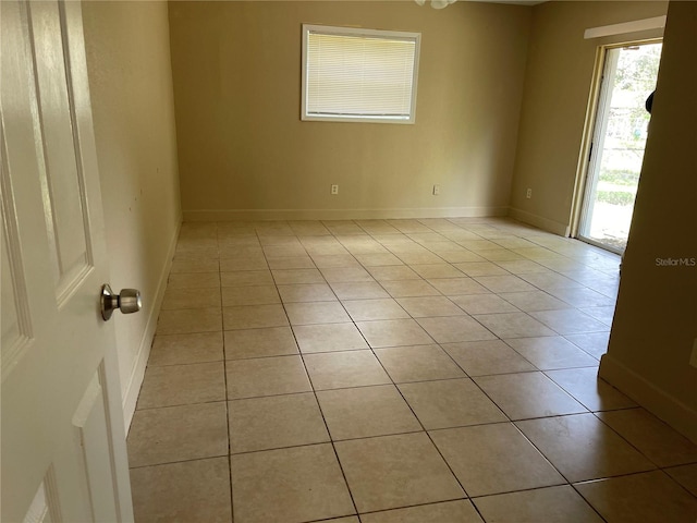 unfurnished room featuring light tile patterned flooring