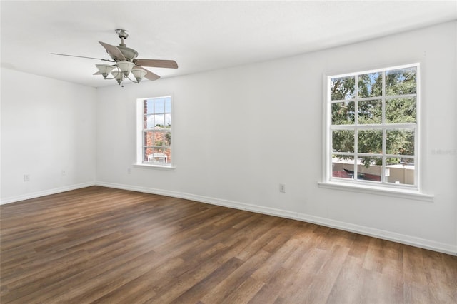 spare room featuring dark wood-type flooring and ceiling fan