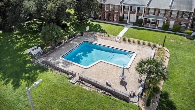 view of swimming pool with a lawn and a patio