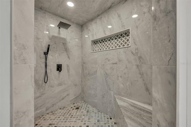 bathroom with a tile shower