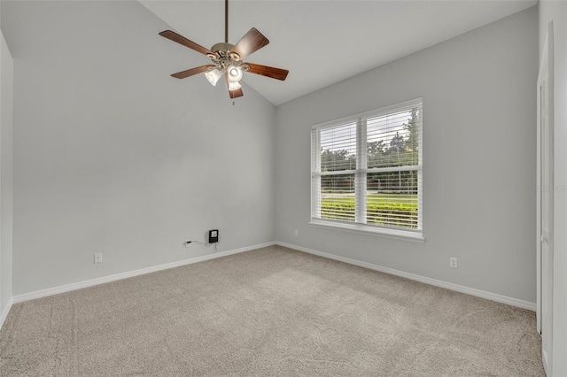 carpeted empty room featuring vaulted ceiling and ceiling fan