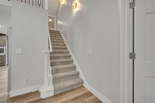 stairs featuring hardwood / wood-style floors