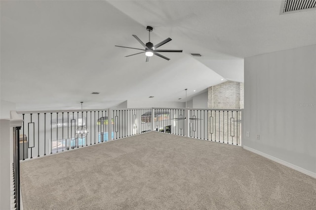 carpeted empty room featuring vaulted ceiling and ceiling fan