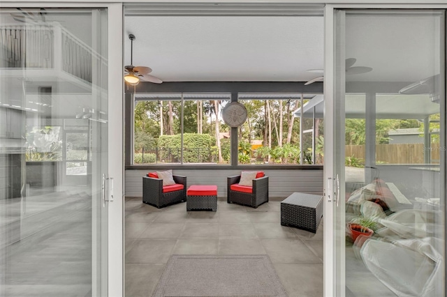 sunroom featuring ceiling fan