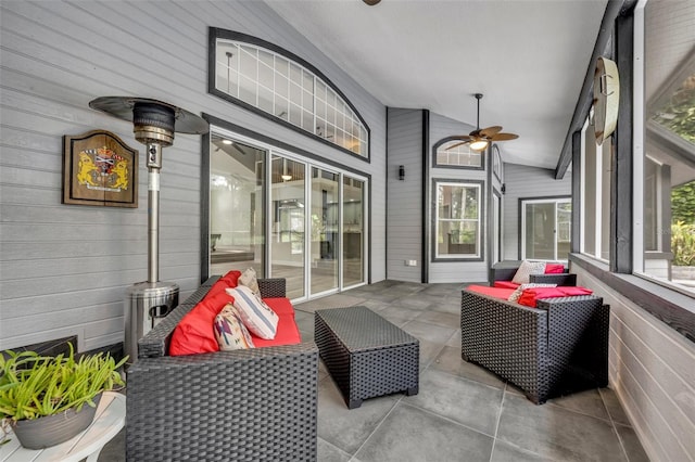 sunroom / solarium featuring vaulted ceiling, ceiling fan, and a wealth of natural light