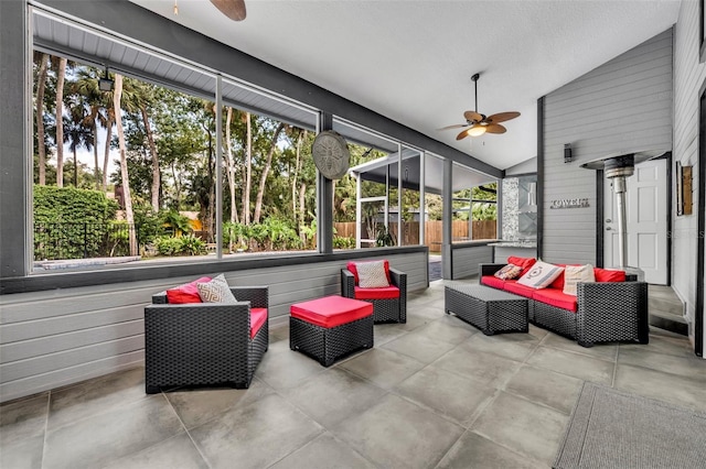 sunroom / solarium featuring lofted ceiling and ceiling fan