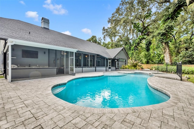 view of pool featuring a sunroom and a patio area