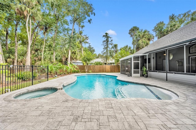 view of swimming pool with a patio, an in ground hot tub, and a sunroom