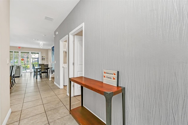 corridor featuring light tile patterned floors