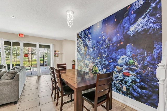 dining room with a textured ceiling and light tile patterned floors