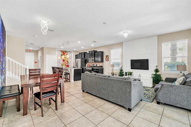 tiled living room featuring a textured ceiling