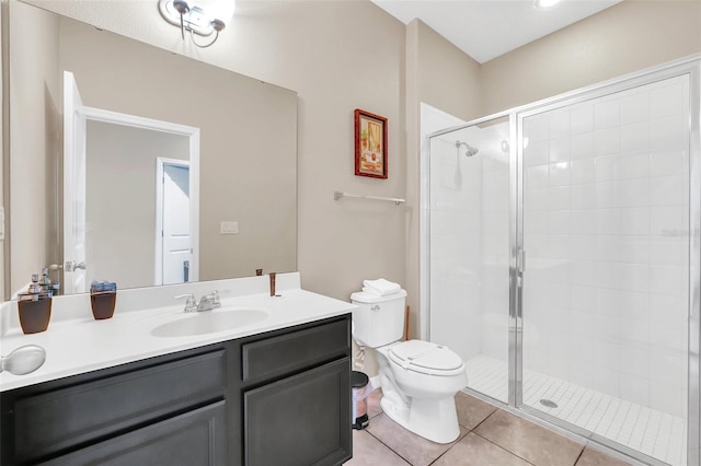 bathroom featuring vanity, toilet, tile patterned floors, and a shower with door