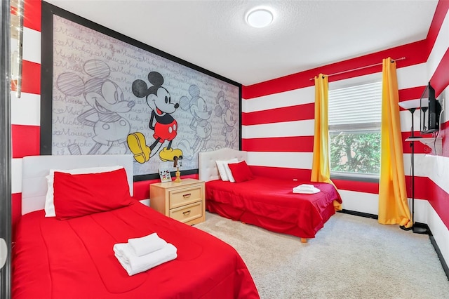 bedroom with a textured ceiling and carpet flooring