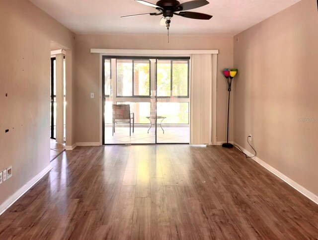 unfurnished room with ceiling fan and hardwood / wood-style flooring