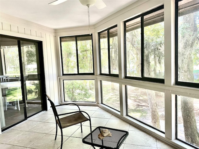 sunroom / solarium with a healthy amount of sunlight and ceiling fan