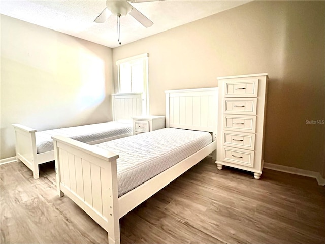 bedroom with wood-type flooring and ceiling fan