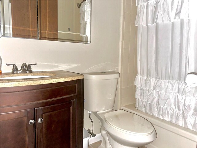 full bathroom featuring shower / tub combo with curtain, vanity, and toilet