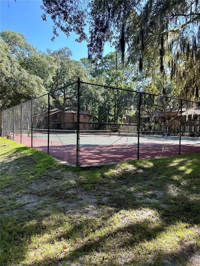 view of sport court featuring a lawn