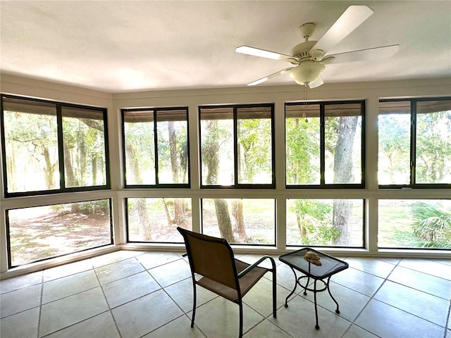 unfurnished sunroom featuring ceiling fan