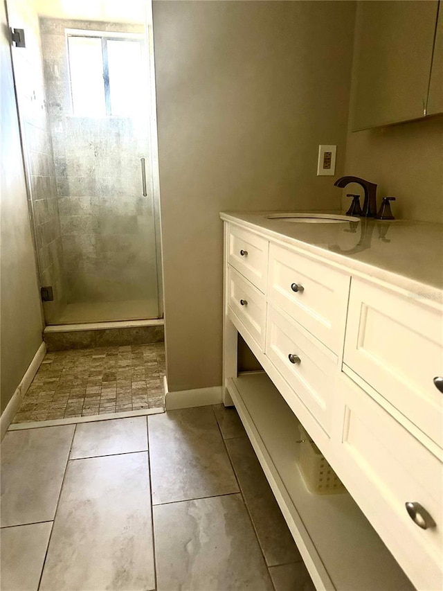 bathroom featuring vanity, an enclosed shower, and tile patterned floors