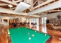 recreation room with pool table, hardwood / wood-style floors, and a high ceiling