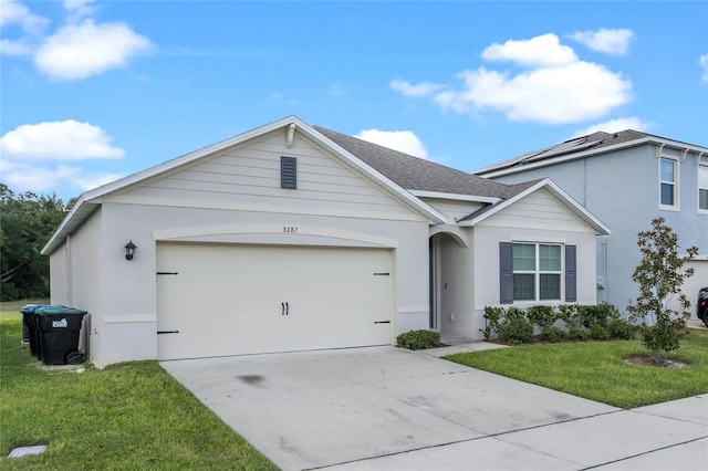 ranch-style home with a garage and a front yard