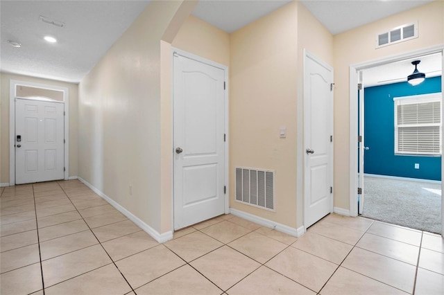 corridor with light tile patterned floors