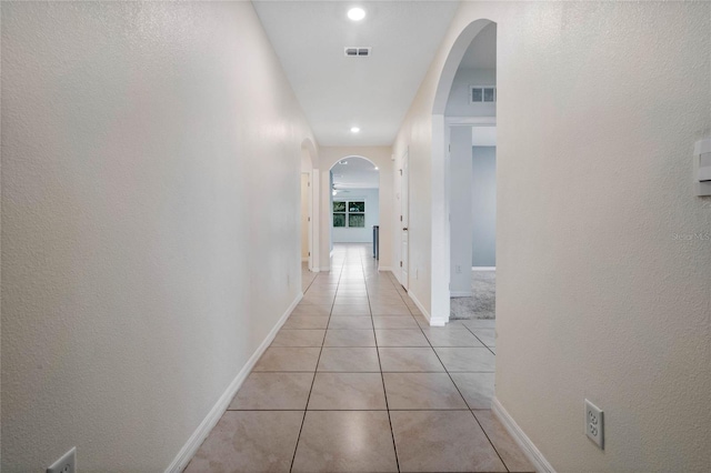 corridor with light tile patterned flooring