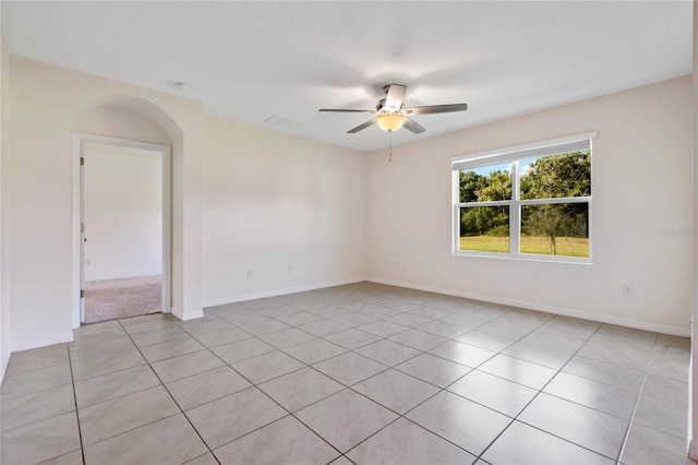 spare room with ceiling fan and light tile patterned floors