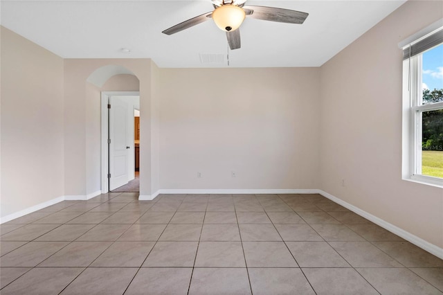 unfurnished room with ceiling fan and light tile patterned floors