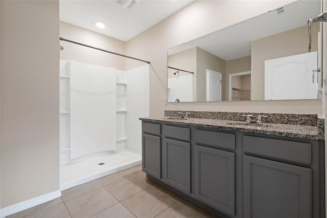 bathroom featuring walk in shower, vanity, and tile patterned floors