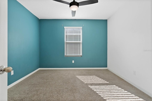 carpeted spare room with ceiling fan