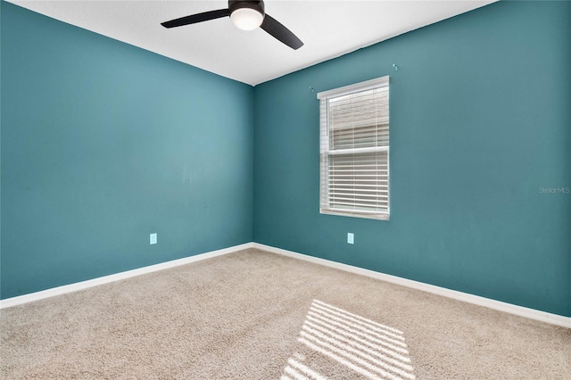 spare room with carpet floors and ceiling fan