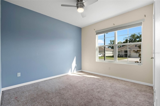 carpeted spare room with ceiling fan