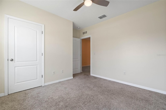 unfurnished bedroom featuring light carpet and ceiling fan