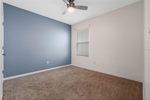 empty room with ceiling fan and carpet flooring