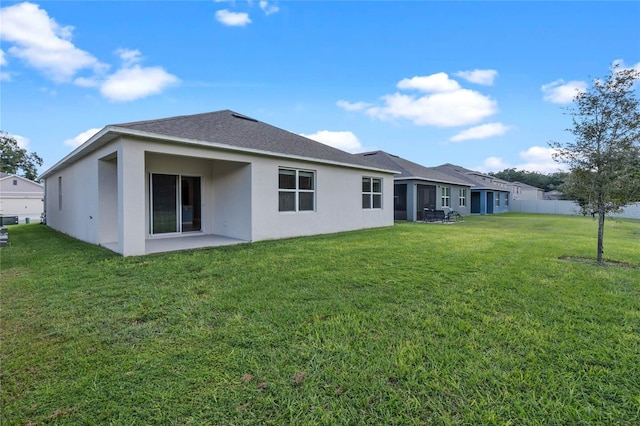 rear view of property with a yard