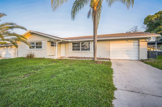 ranch-style home with a front yard and a garage