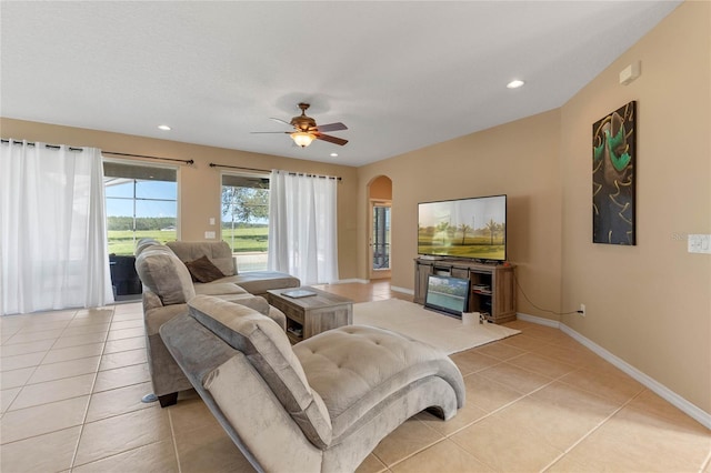 tiled living room featuring ceiling fan