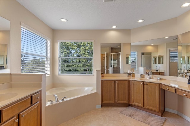 bathroom featuring vanity, a textured ceiling, tile patterned floors, and independent shower and bath