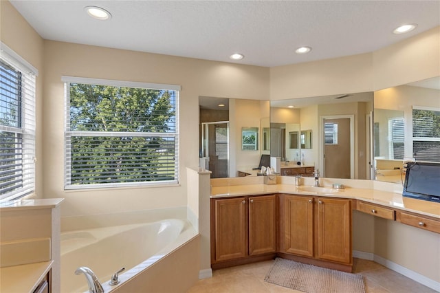 bathroom with tile patterned floors, vanity, a textured ceiling, and independent shower and bath