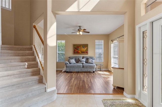 entryway with ceiling fan, a wealth of natural light, and light hardwood / wood-style flooring