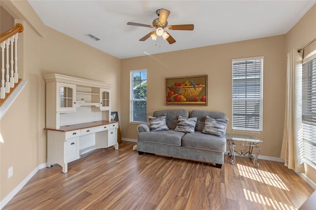 living room featuring hardwood / wood-style floors and ceiling fan