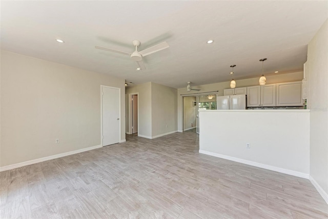 spare room with ceiling fan and light hardwood / wood-style flooring