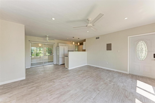 unfurnished living room featuring light wood-type flooring and ceiling fan