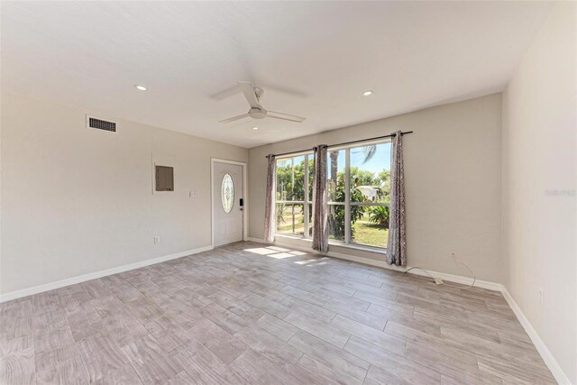 empty room with light hardwood / wood-style flooring and ceiling fan